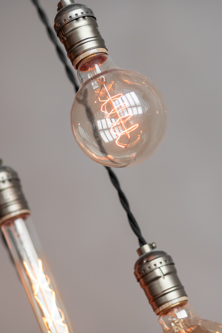 modern industrial lightbulb close up wired hanging